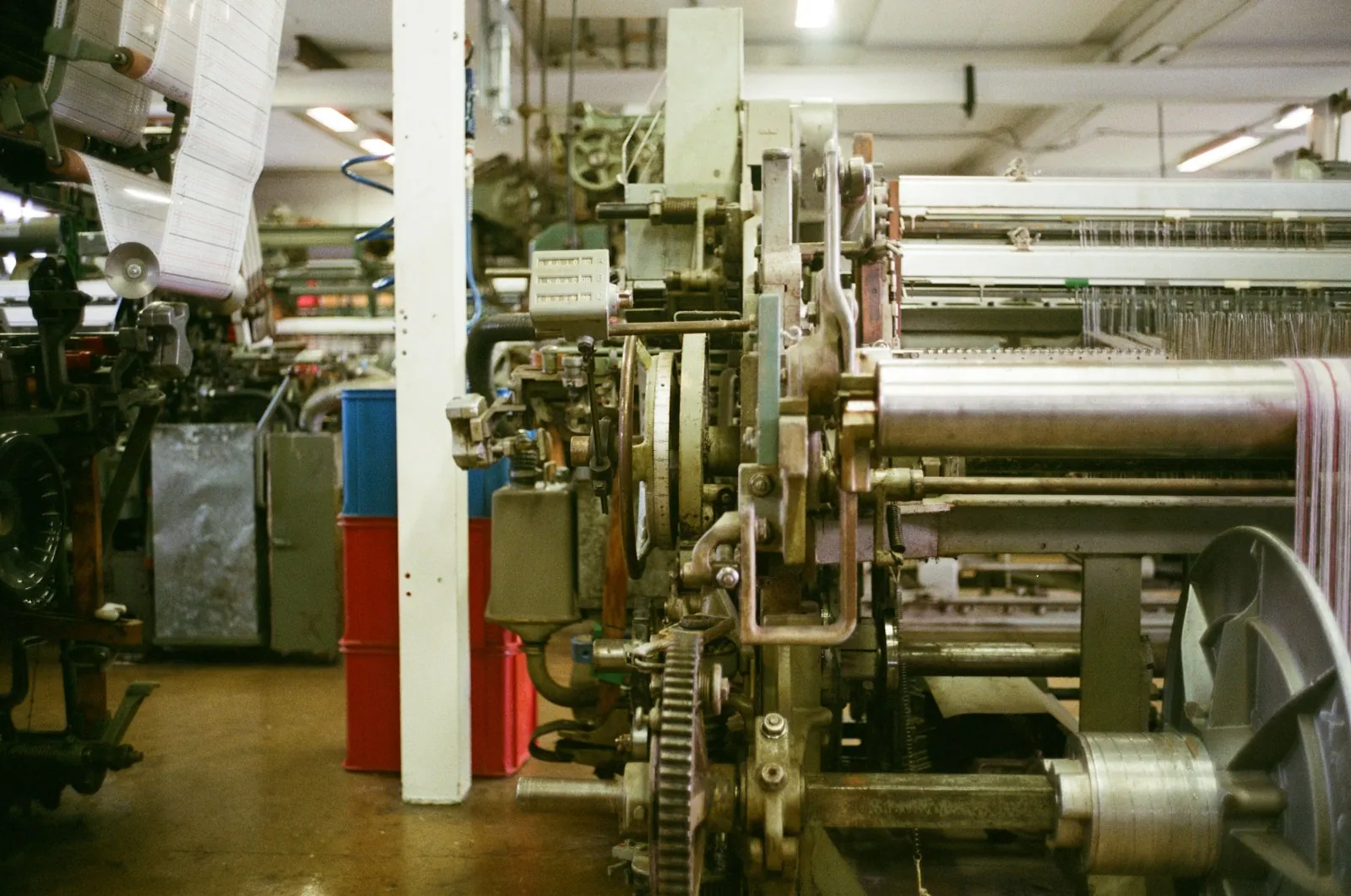 Weaving looms at work on a textile floor